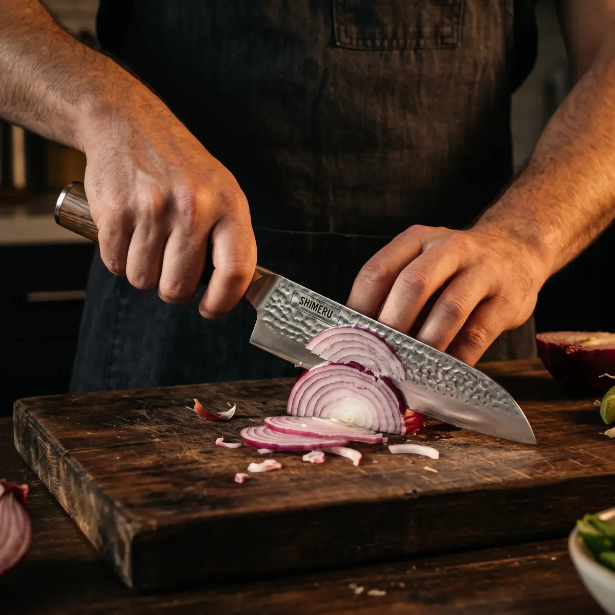 Raikou 6.5" Santoku Knife slicing a red onion paper thin
